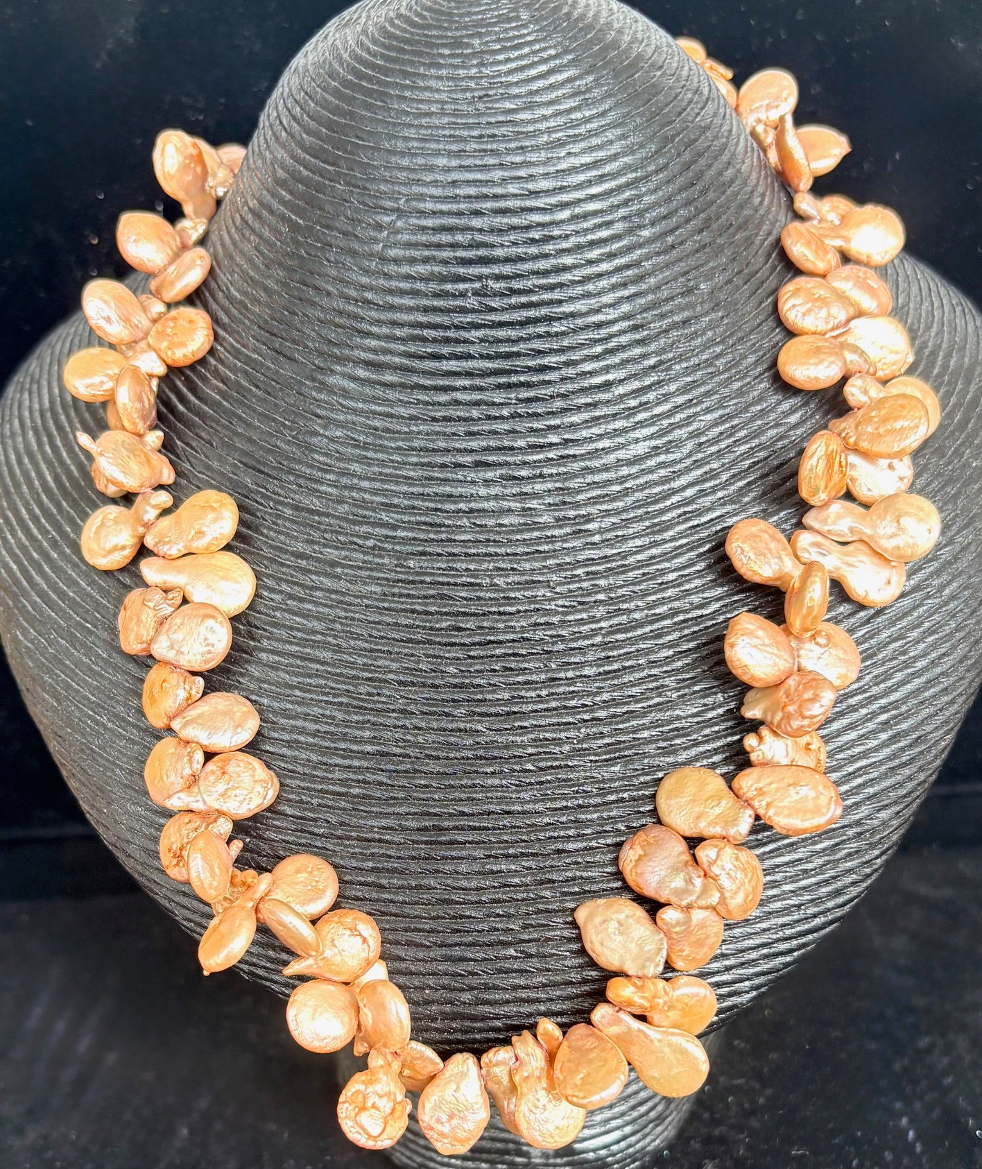 Jolie Esprit Bronze Keshi Pearl Necklace on a gray stand against a black background