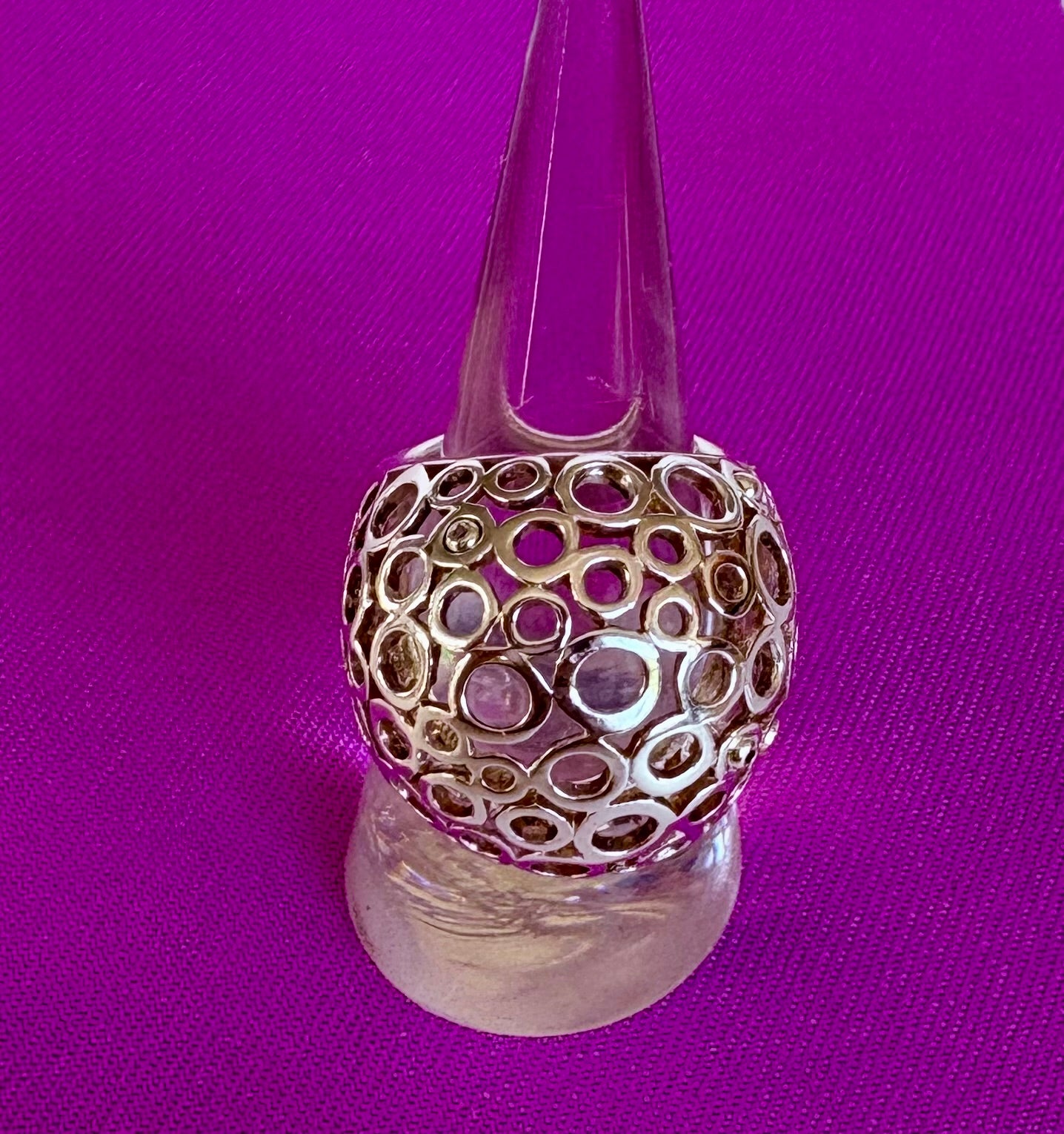 Decorative ring with intricate design on a purple background