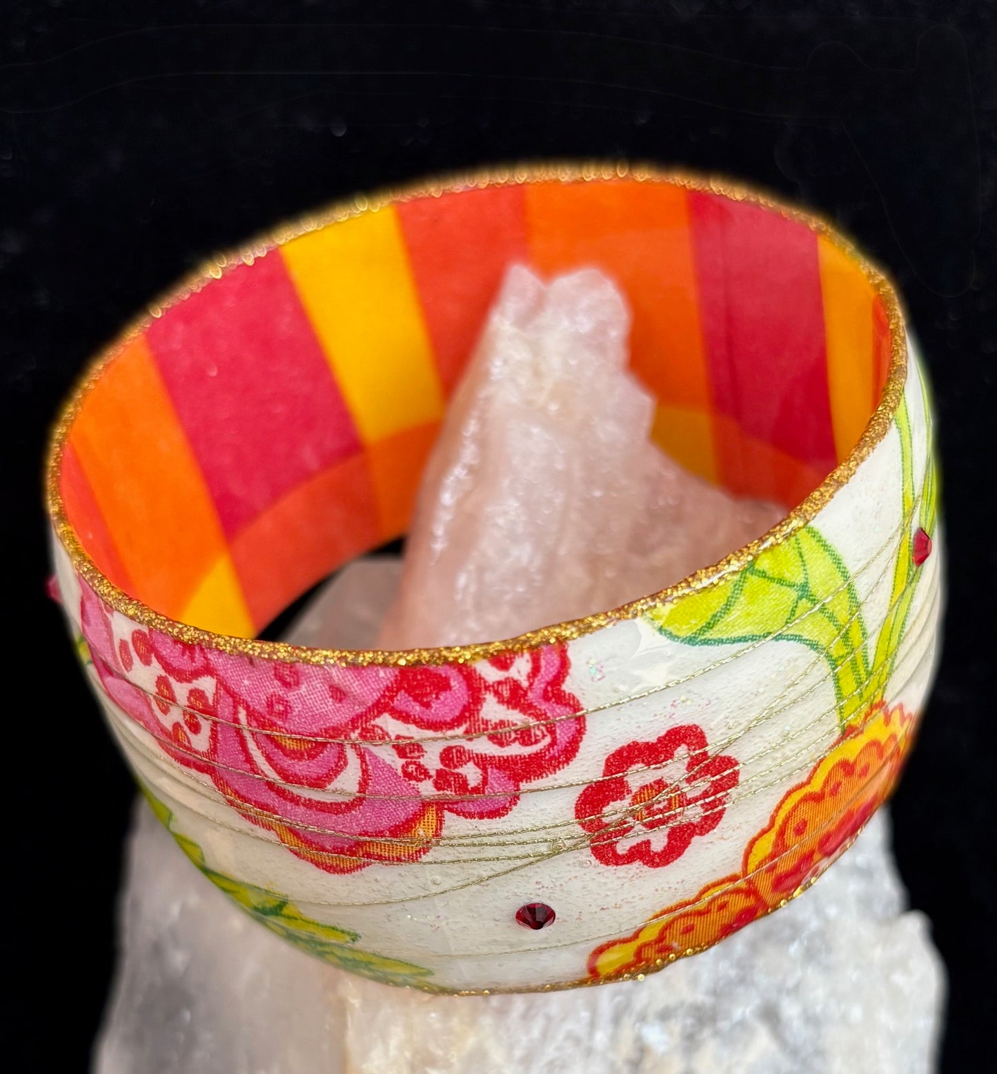 Colorful bracelet with floral design on a black background