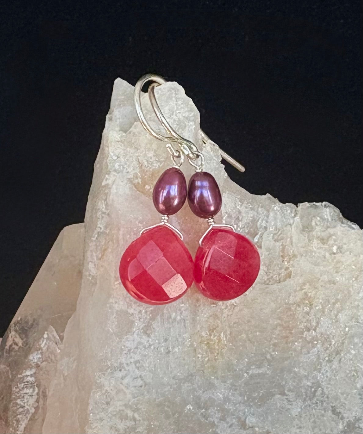 Fuchsia Pink gemstone and purple pearl earrings on a crystal background