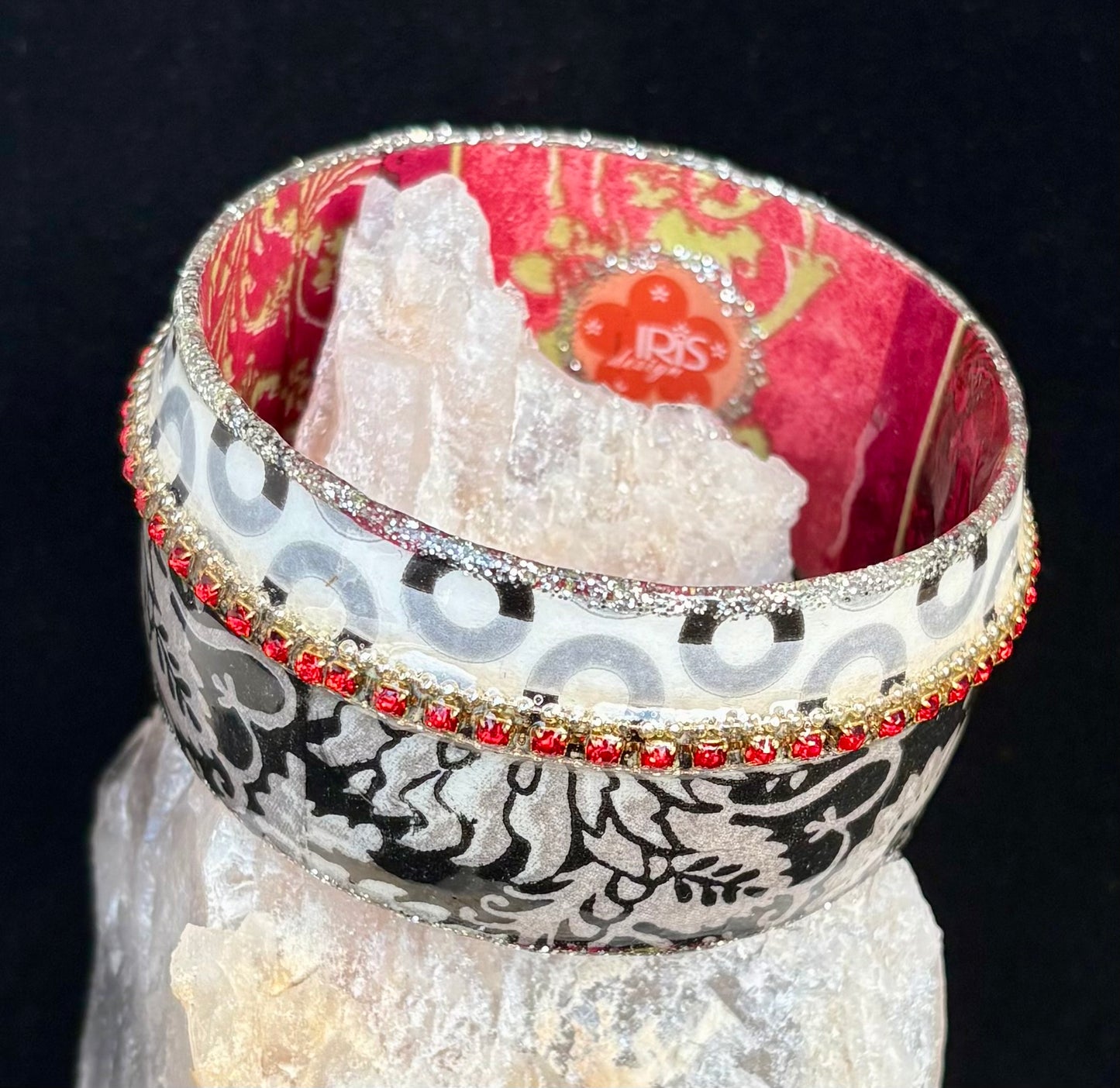 Decorative bangle with intricate patterns on a black background