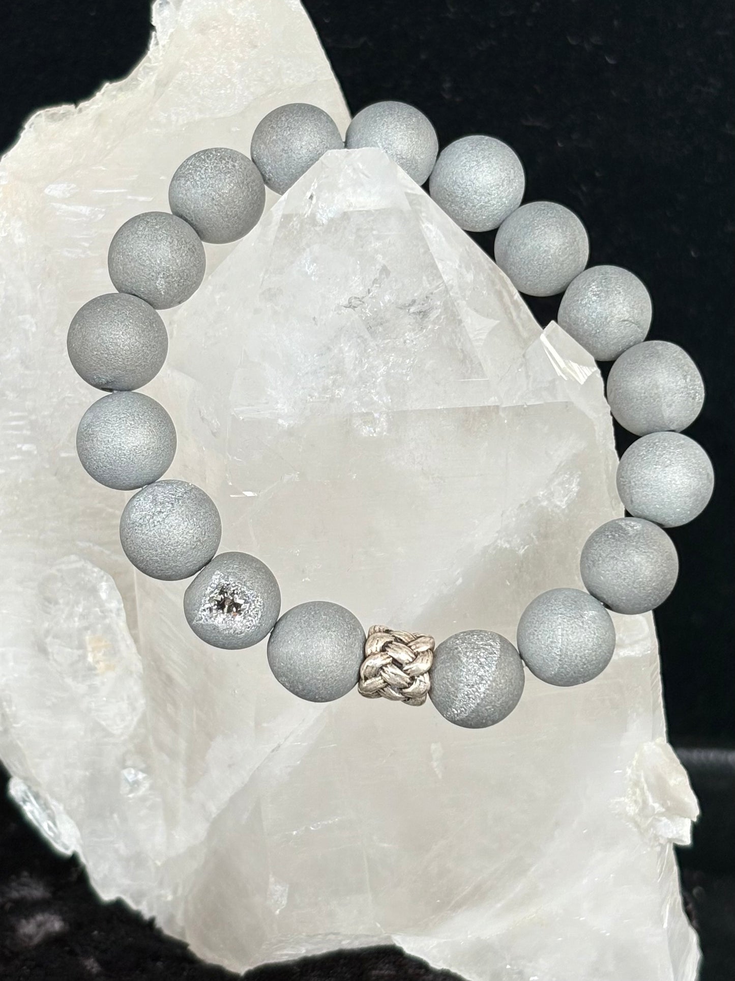Jolie Esprit gray beaded bracelet with a braided design sterling silver bead on a white crystal background