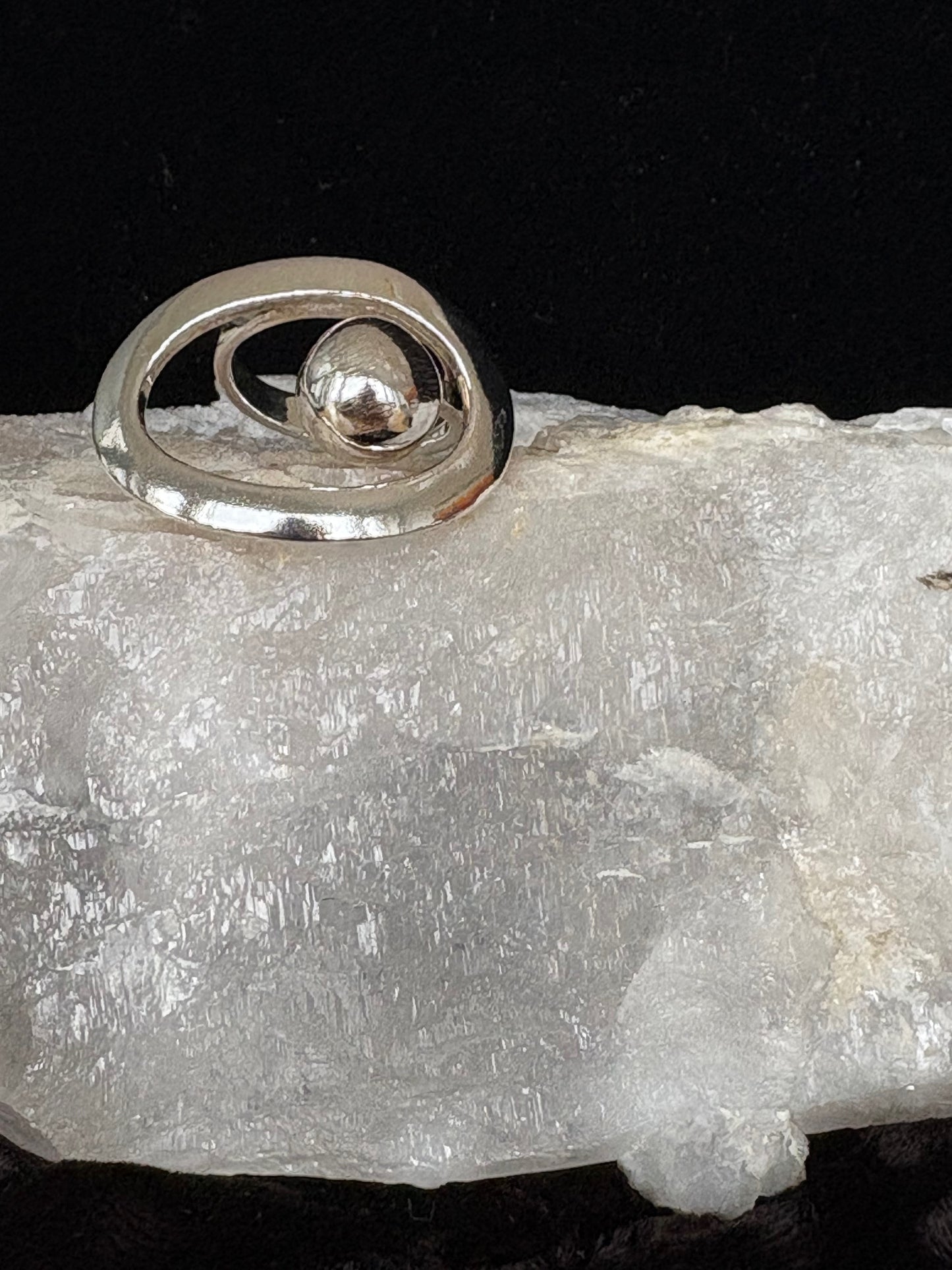 Silver ring with a central design on a clear crystal background