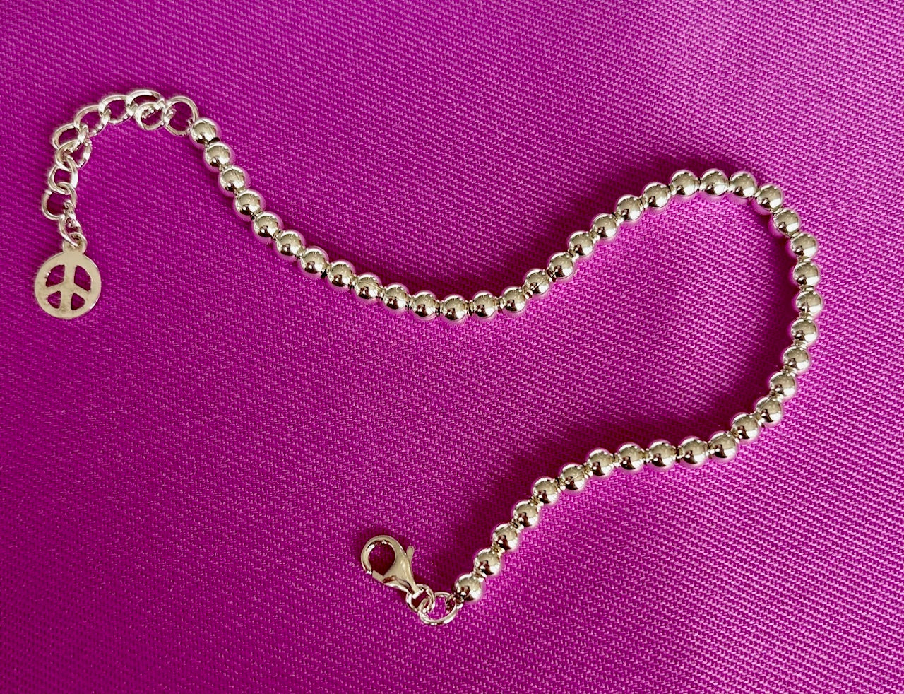 Jolie Esprit Sterling Silver ball bracelet on a purple background