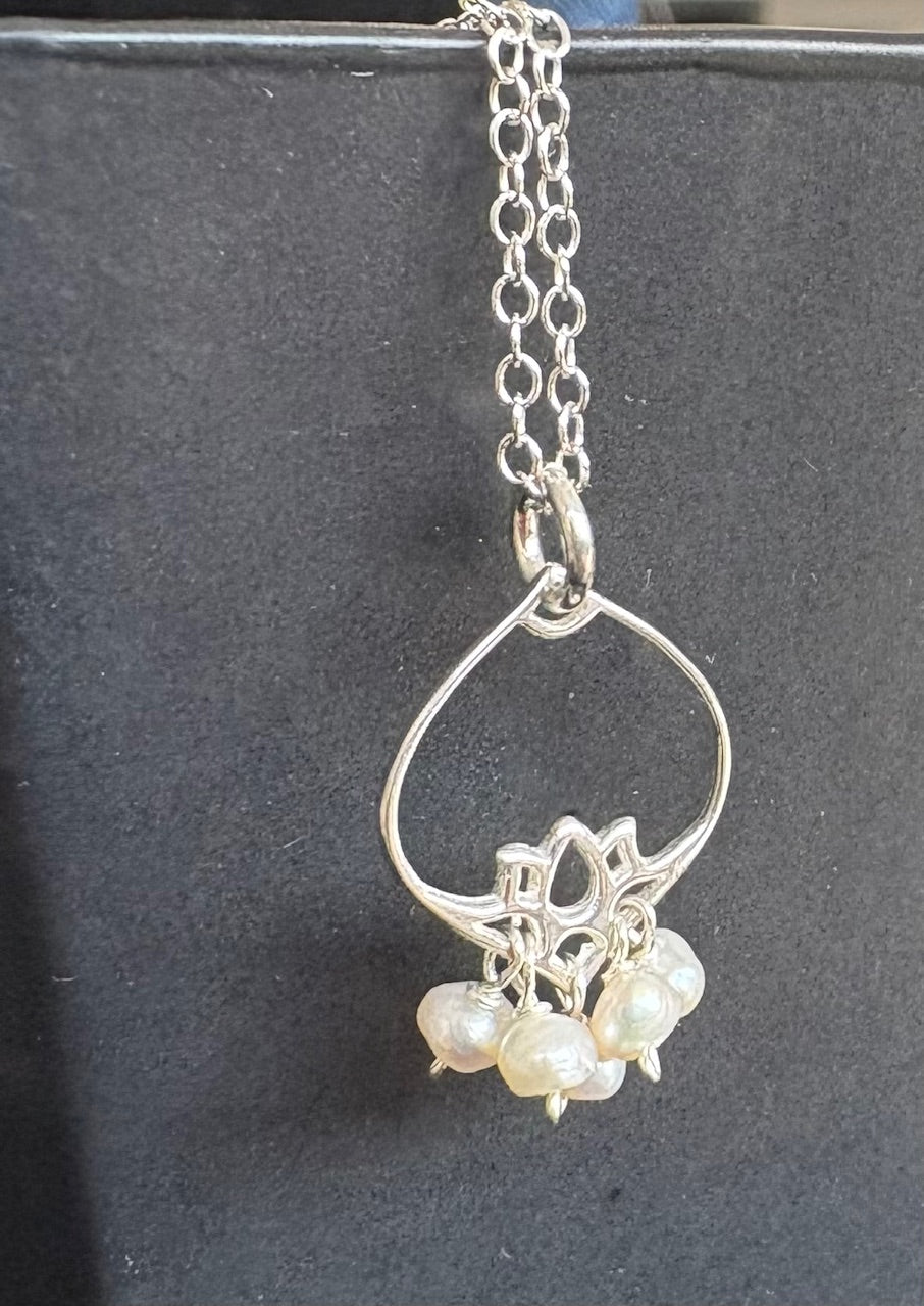 Jolie Esprit sterling silver necklace with a teardrop-shaped pendant featuring three pearls on a dark background