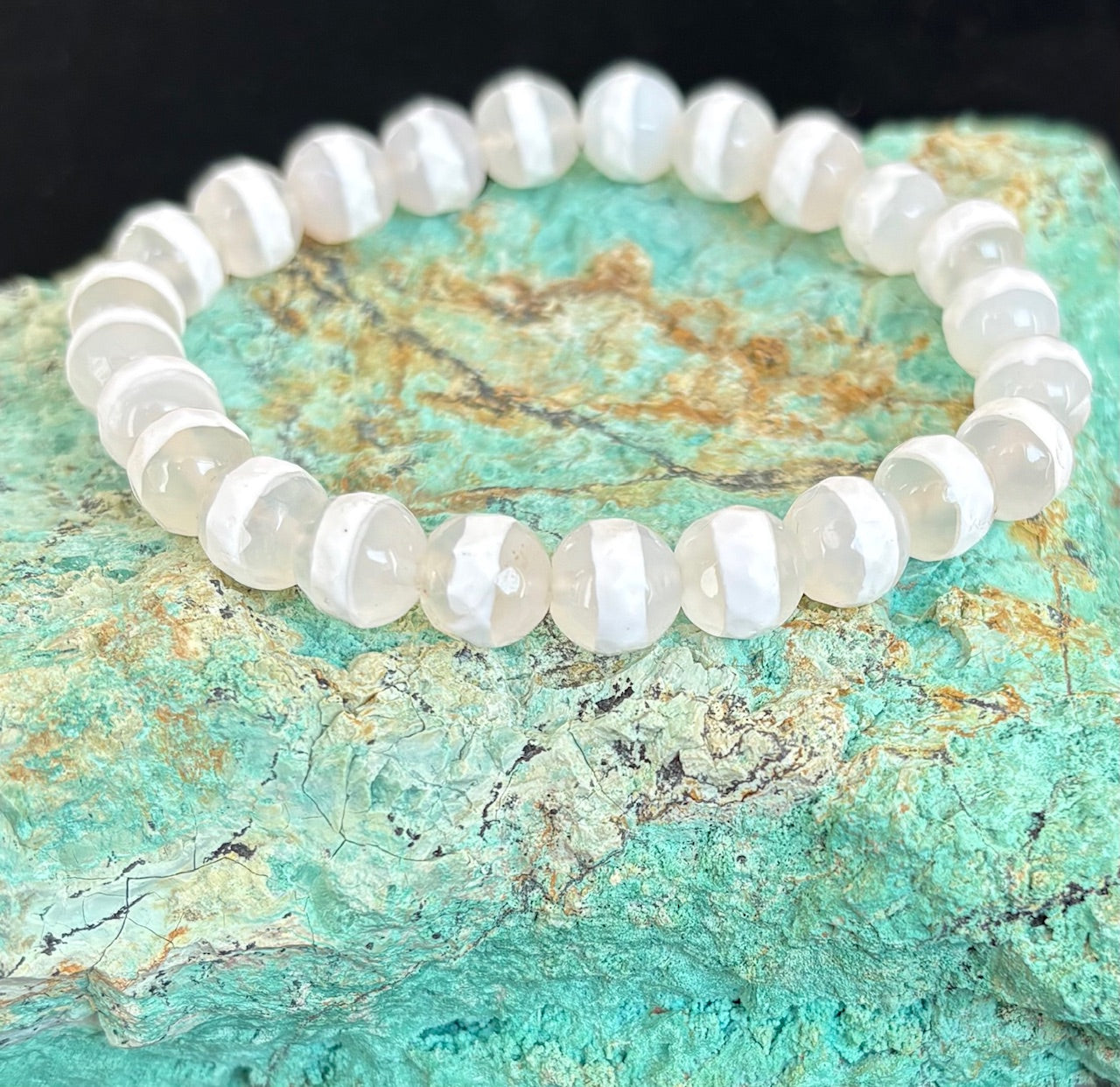 White Agate Stretch bracelet on a textured turquoise stone