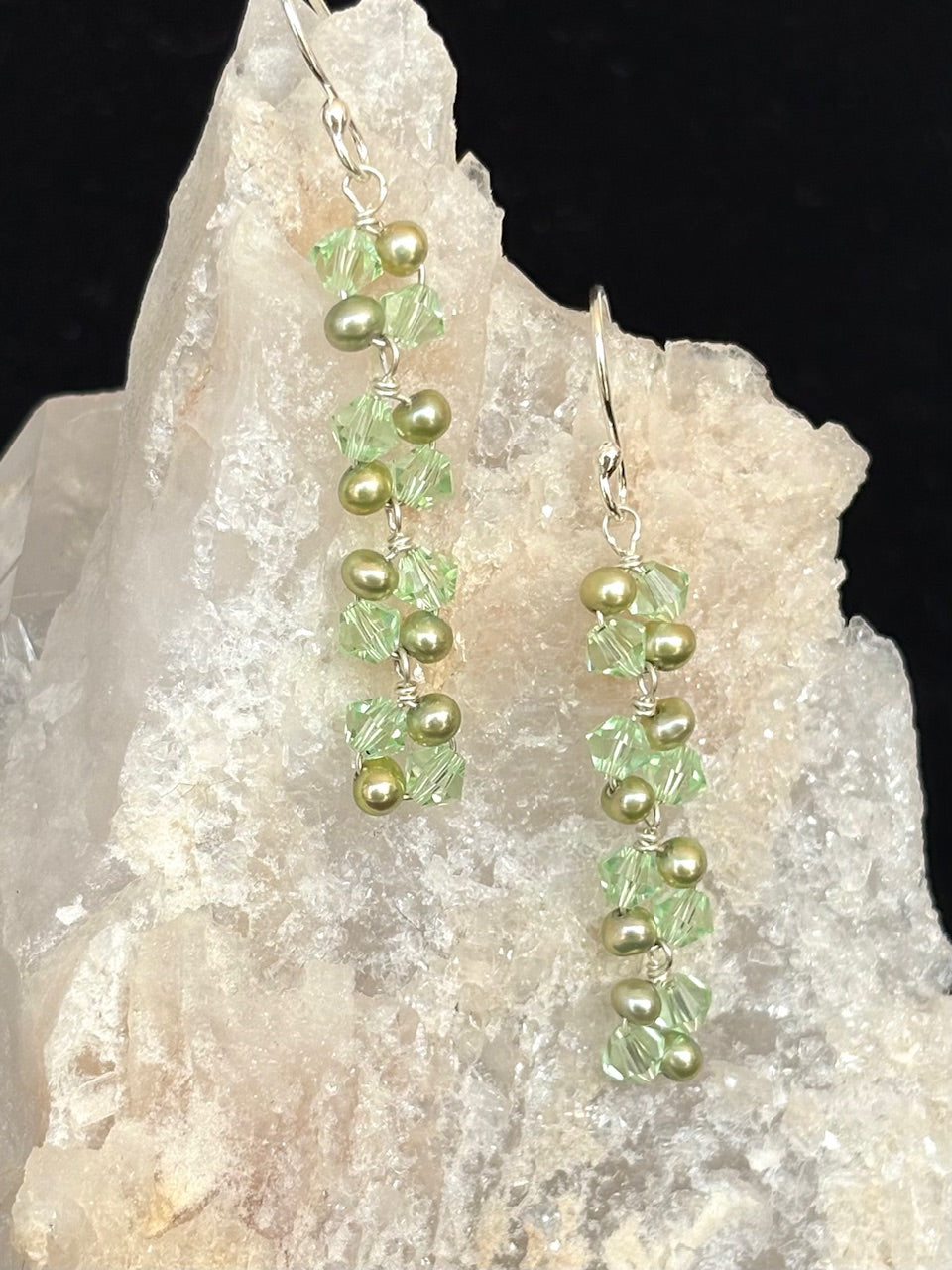 Jolie Esprit light green swarovski and pearl earrings on a rock background