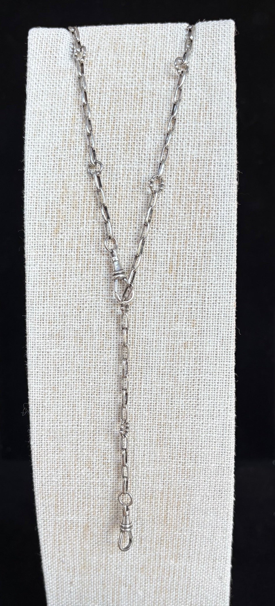 Sterling silver necklace on a white card with a black background