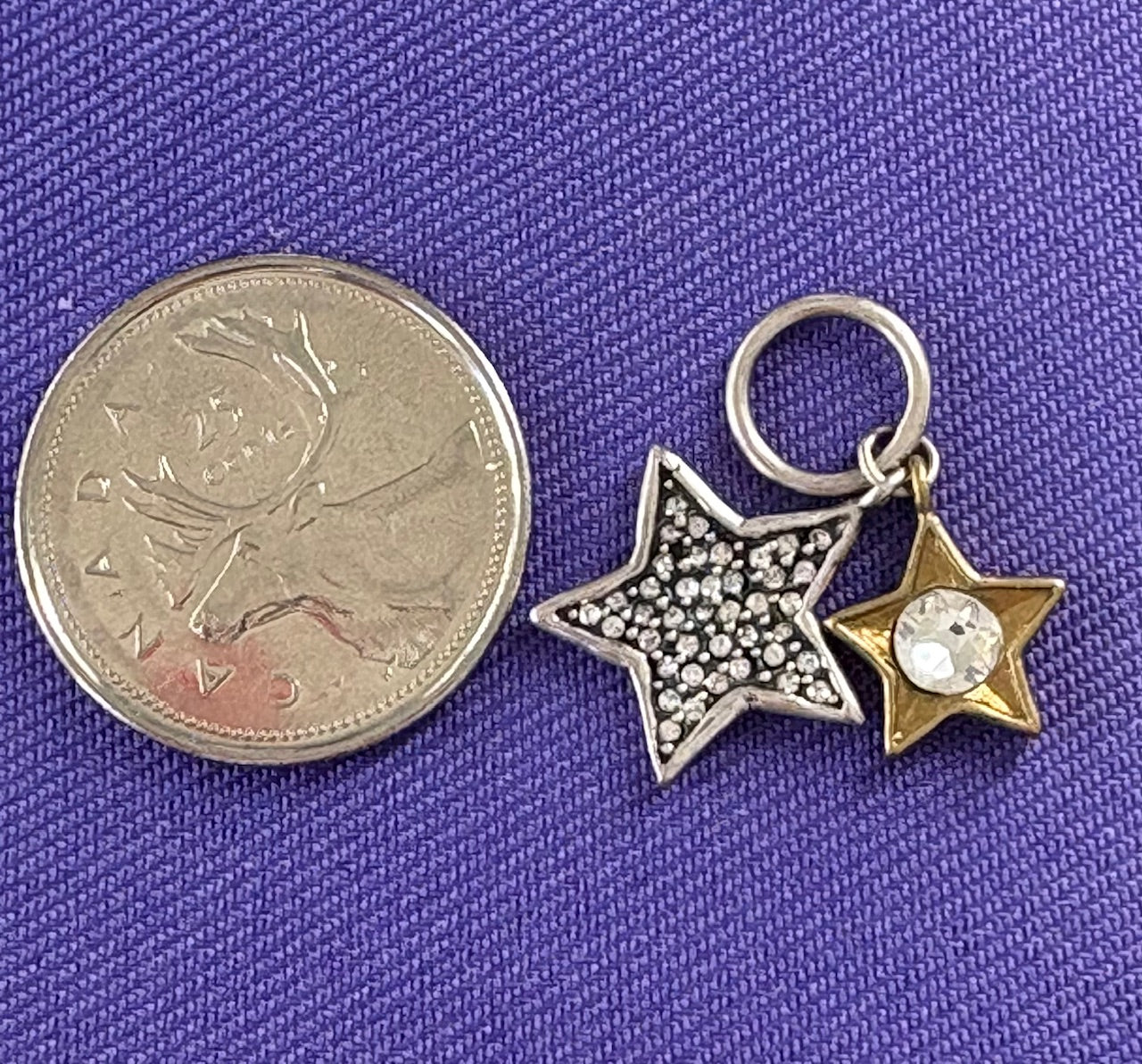 Star-shaped charms on a purple fabric background. Waxing Poetic