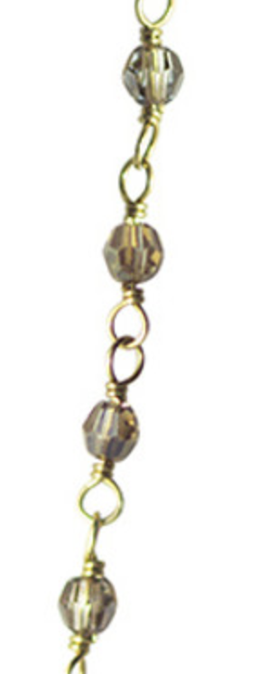 Gold chain with silver beads on a white background. Waxing Poetic