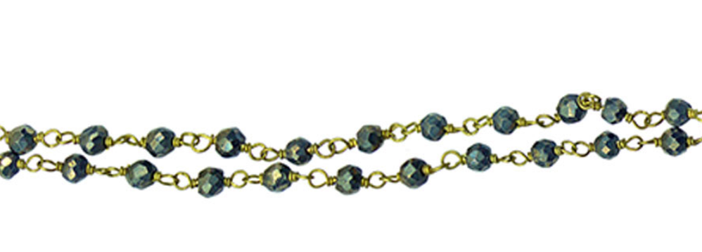 Gold chain with black beads on a white background