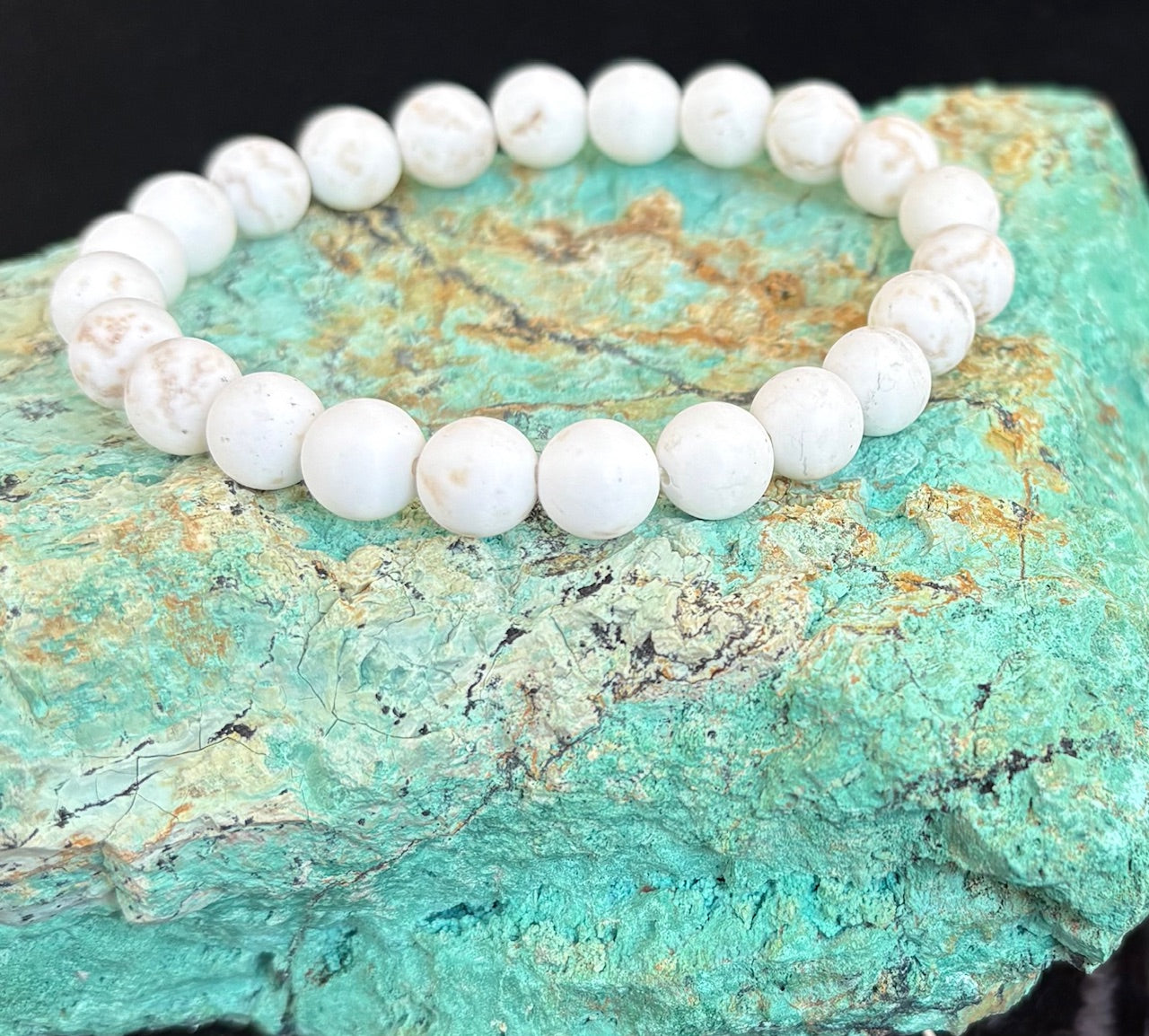 White turquoise beaded stretchy bracelet on a turquoise stone