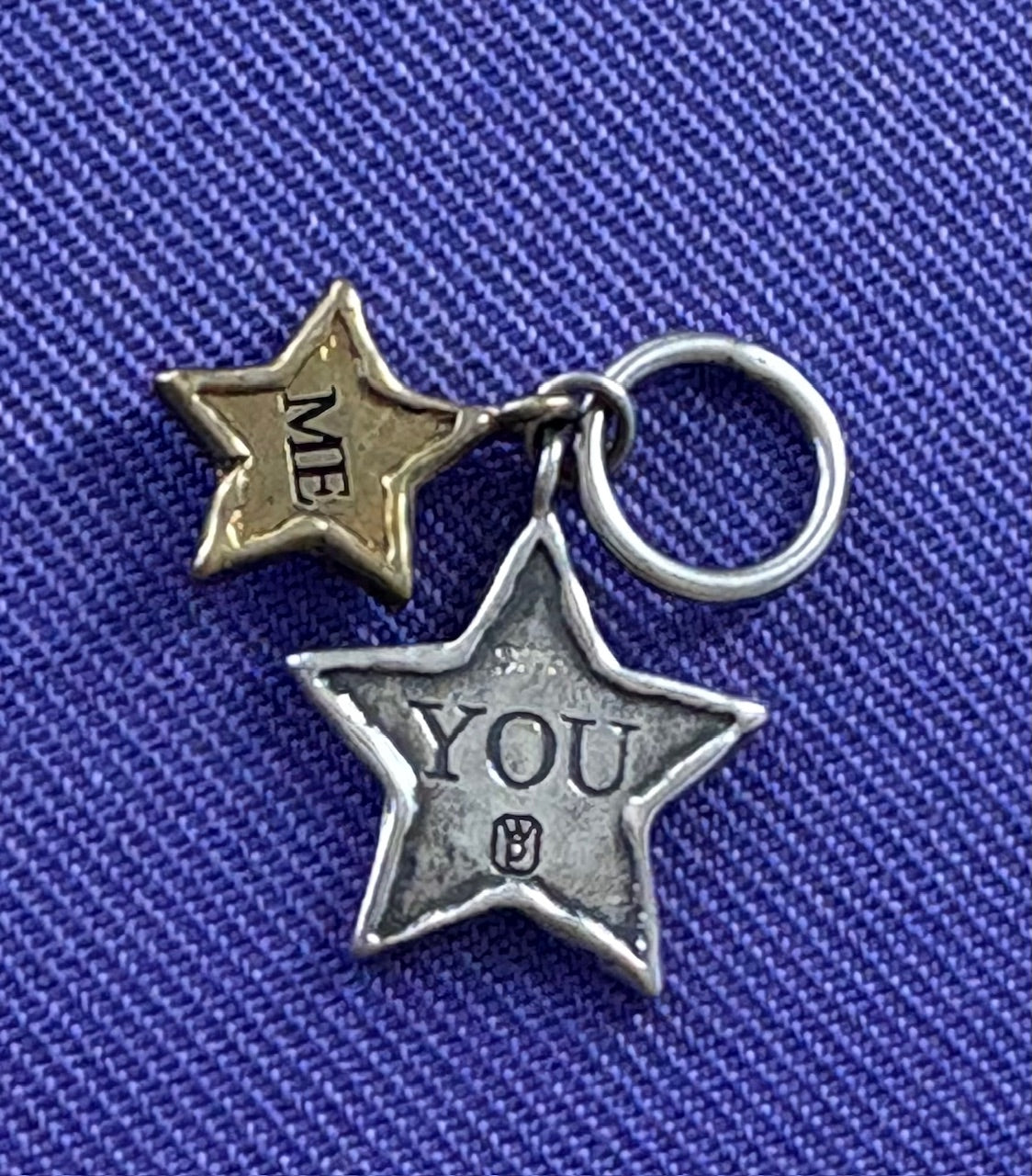 Two star-shaped charms on a blue background, one labeled 'ME' and the other 'YOU'. Waxing Poetic