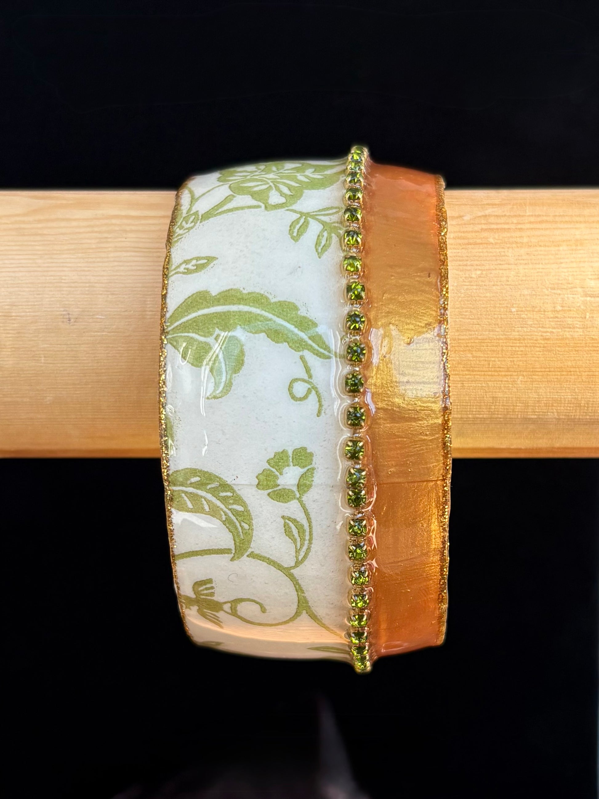 Decorative bangle with green floral pattern by Iris Design