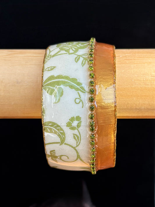 Decorative bangle with green floral pattern by Iris Design