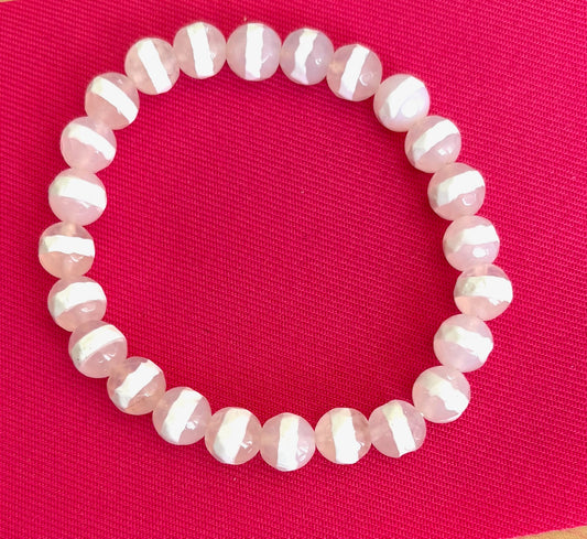 White beaded bracelet on a red background