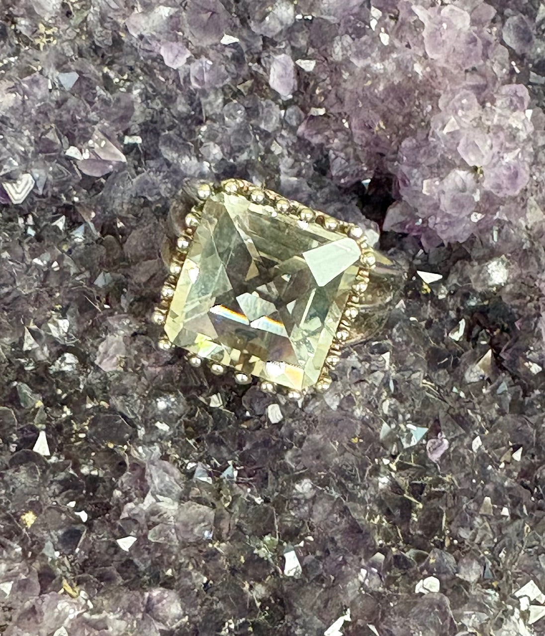 Green gemstone ring on a crystal background
