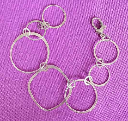 Sterling silver large free form  link bracelet on a purple background by Jolie Esprit