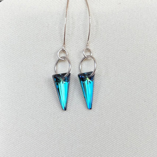 Blue spike earrings on a light gray background