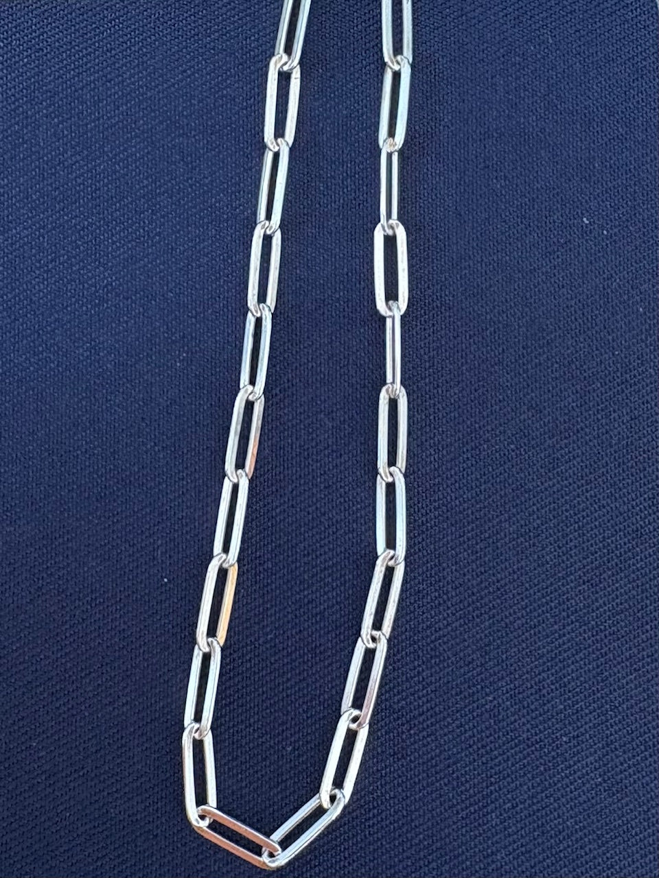 Jolie Esprit sterling silver chain necklace on a blue fabric background