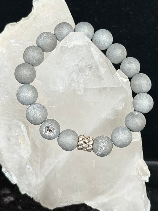 Jolie Esprit gray beaded bracelet with a braided design sterling silver bead on a white crystal background
