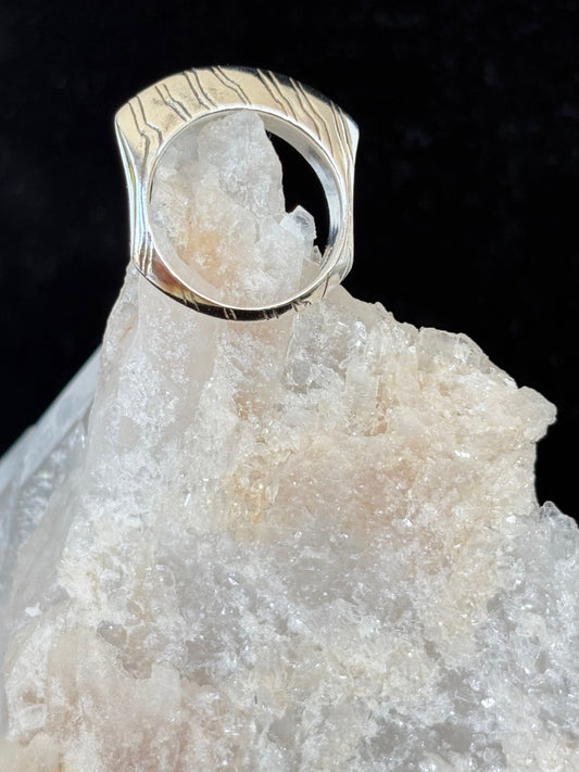 Silver ring with a unique design on a crystal background