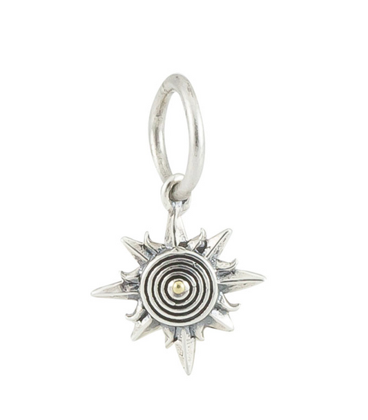 Silver sun-shaped charm on a white background