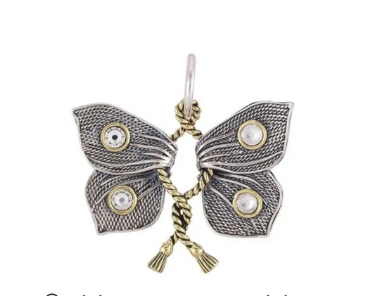 Butterfly-shaped pendant with intricate design on a white background