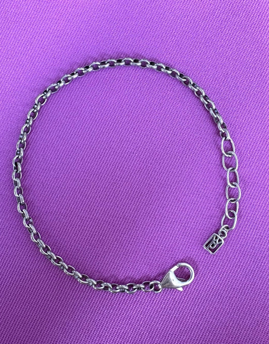Waxing Poetic sterling silver chain bracelet on a purple background