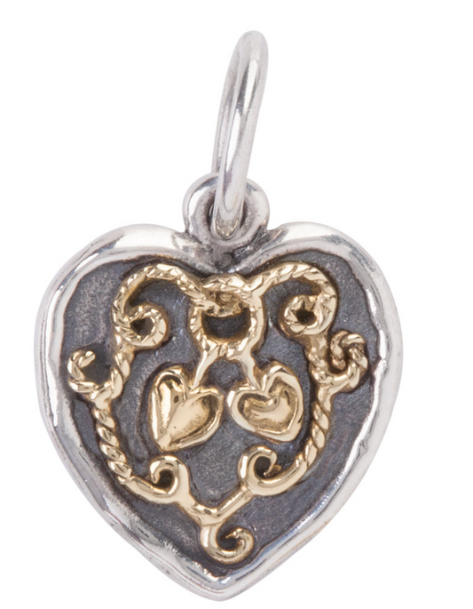 Heart-shaped pendant with intricate design on a white background. Made by Waxing Poetic.