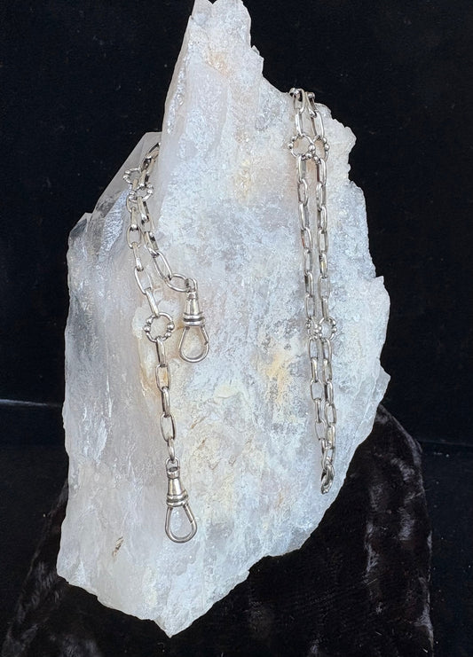 Waxing Poetic sterling silver Everything chain necklace on a large crystal with a dark background
