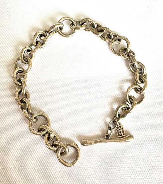 Sterling Silver  chain bracelet with a Toggle Clasp on a white fabric background