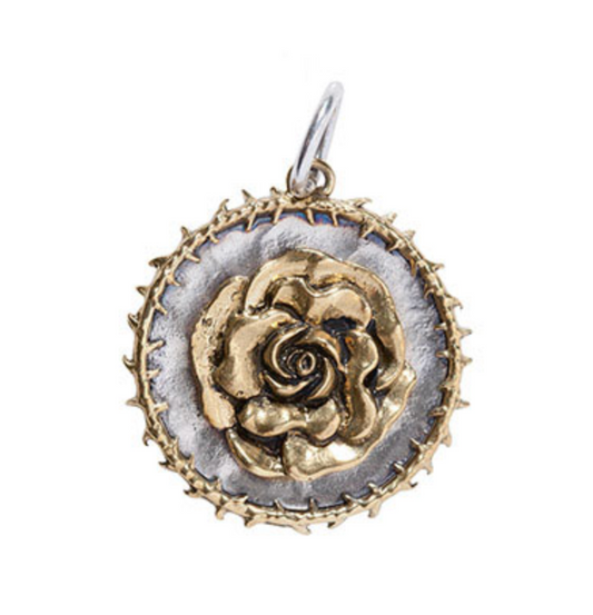 Gold and silver rose-shaped pendant on a white background